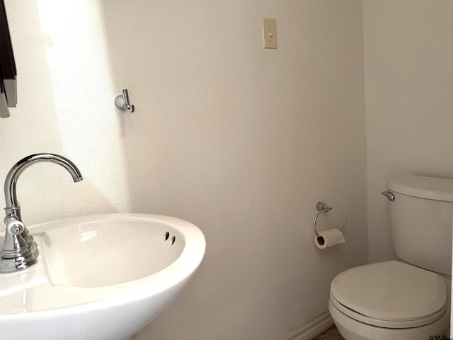 bathroom featuring sink and toilet