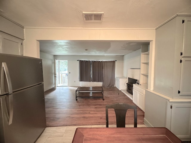 living room featuring light hardwood / wood-style flooring and built in features