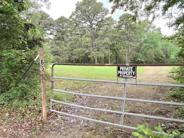 view of gate featuring a lawn