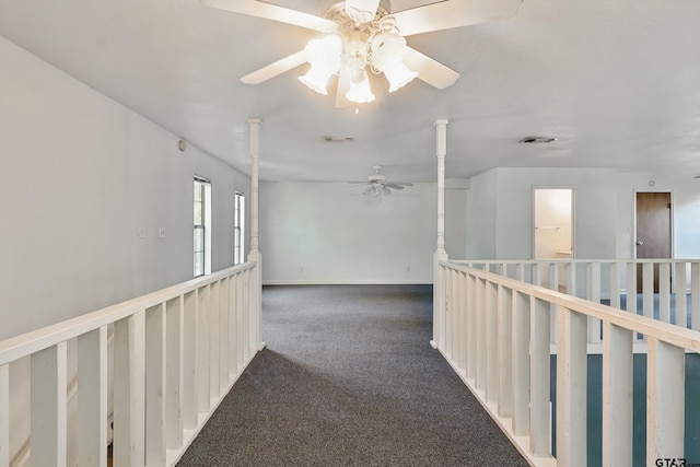corridor with baseboards, carpet flooring, and visible vents