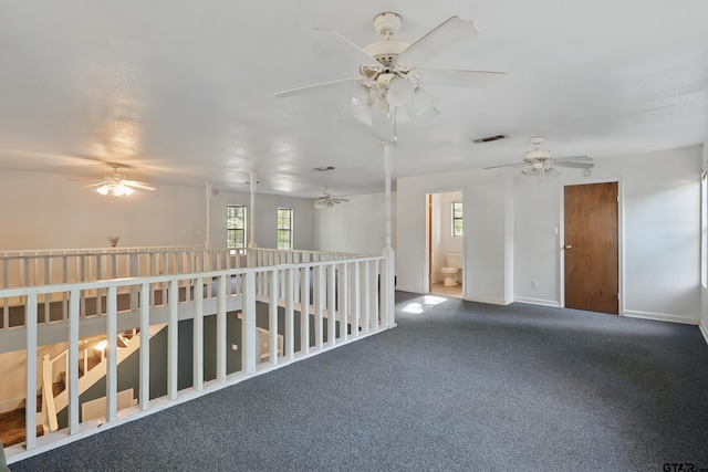 empty room with a ceiling fan, visible vents, and plenty of natural light