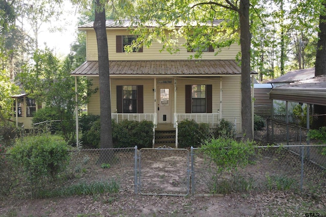 view of front of house with a gate, fence private yard, metal roof, and covered porch
