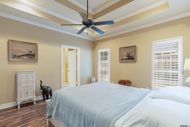 1868 Tall Timber Dr, Tyler, TX 75703 - bedroom featuring dark wood-type flooring, a raised ceiling, crown molding, and ensuite bathroom
