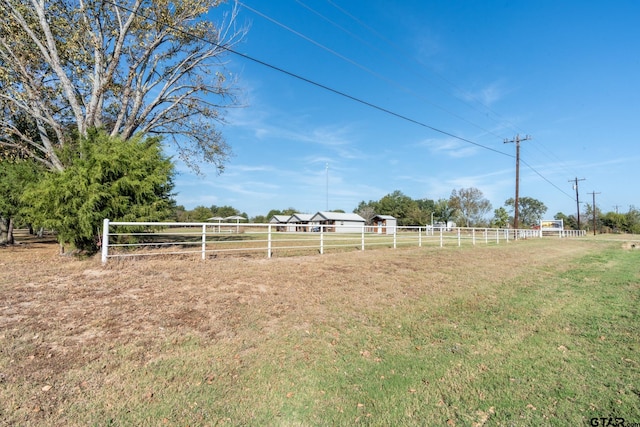 view of yard with a rural view