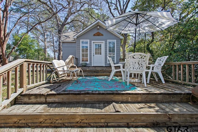 wooden deck featuring an outdoor structure