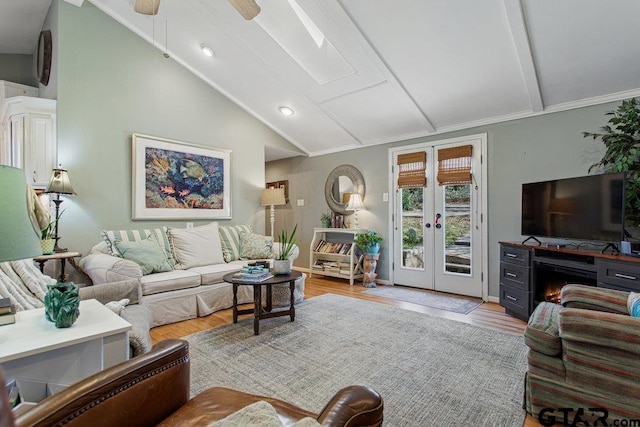 living room with ceiling fan, french doors, vaulted ceiling, and wood finished floors