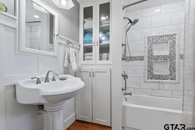 bathroom with shower / bathing tub combination and wood finished floors