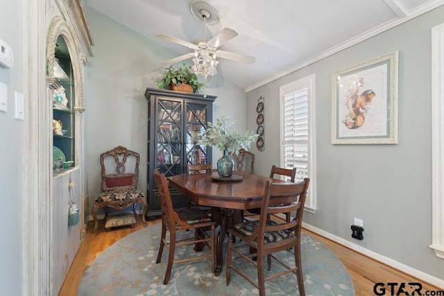 dining area featuring lofted ceiling, light wood finished floors, ceiling fan, and baseboards