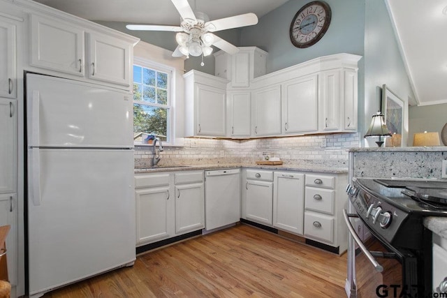 kitchen with light stone countertops, white appliances, and white cabinets