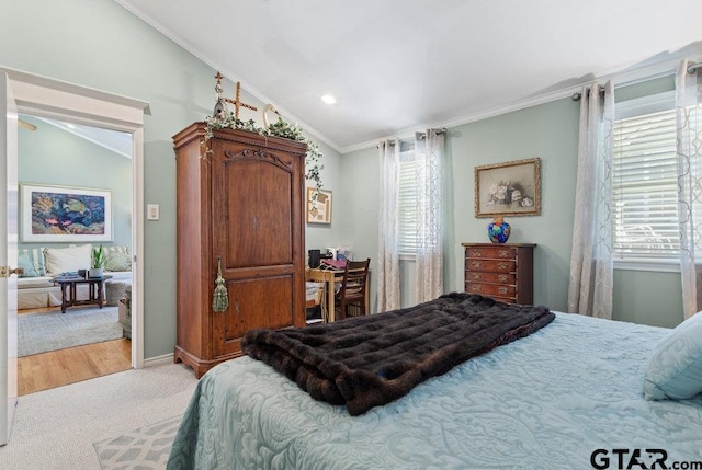 bedroom with lofted ceiling, ornamental molding, multiple windows, and light colored carpet