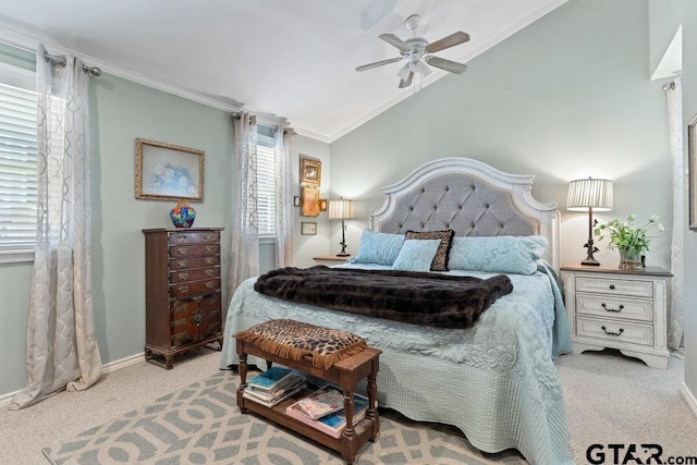 bedroom featuring carpet flooring, a ceiling fan, baseboards, vaulted ceiling, and crown molding