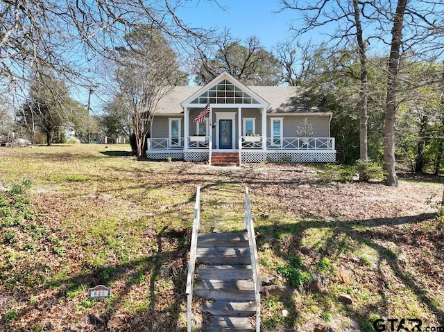 bungalow-style home featuring a porch and a front yard