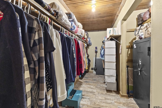 walk in closet with light hardwood / wood-style floors