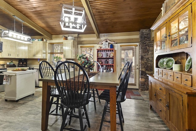 dining area with wood ceiling, wood-type flooring, a notable chandelier, and beamed ceiling