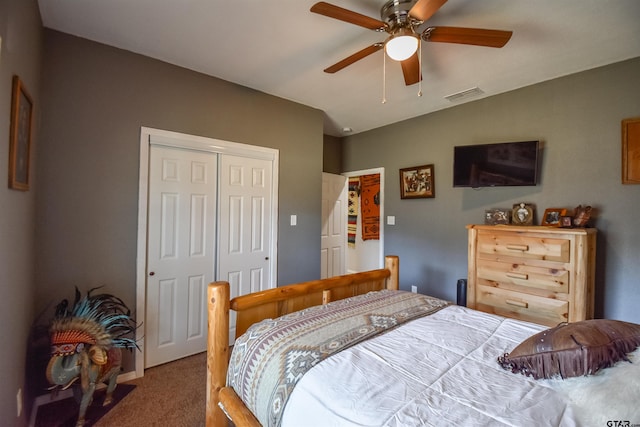 carpeted bedroom featuring a ceiling fan, visible vents, vaulted ceiling, and a closet