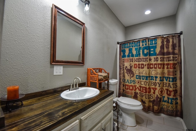 bathroom featuring toilet, curtained shower, tile patterned flooring, and vanity