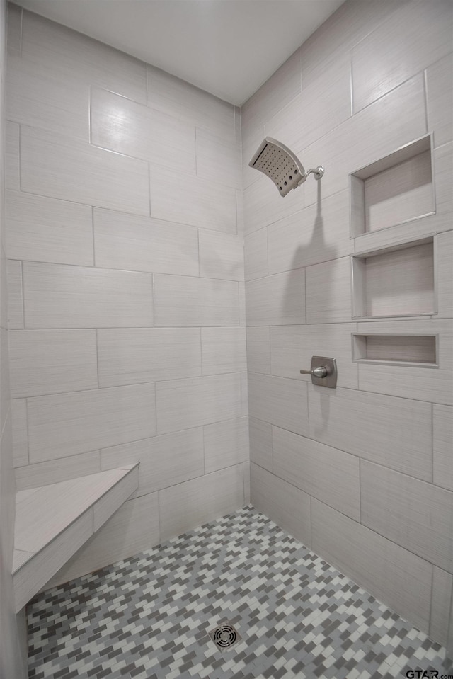 full bathroom with tiled shower