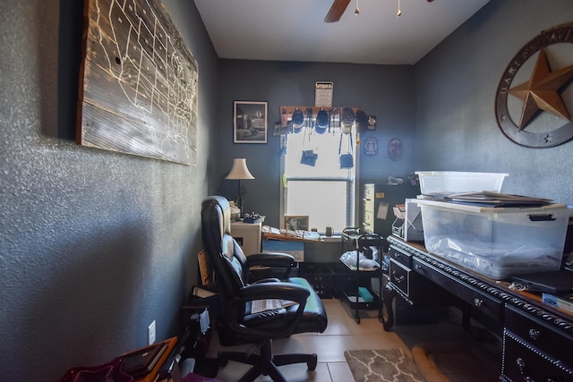 home office with a ceiling fan and tile patterned floors