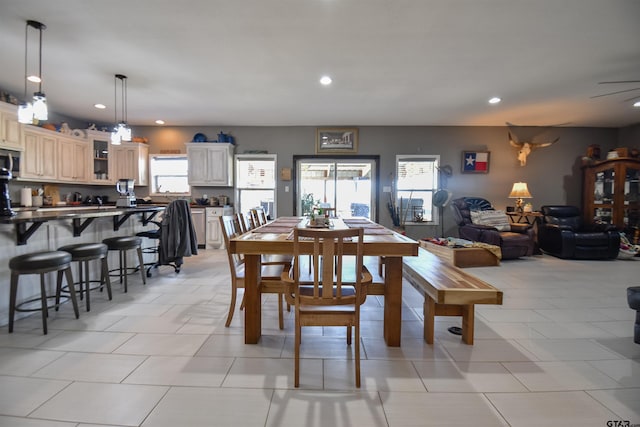 dining space with a healthy amount of sunlight, light tile patterned flooring, and recessed lighting