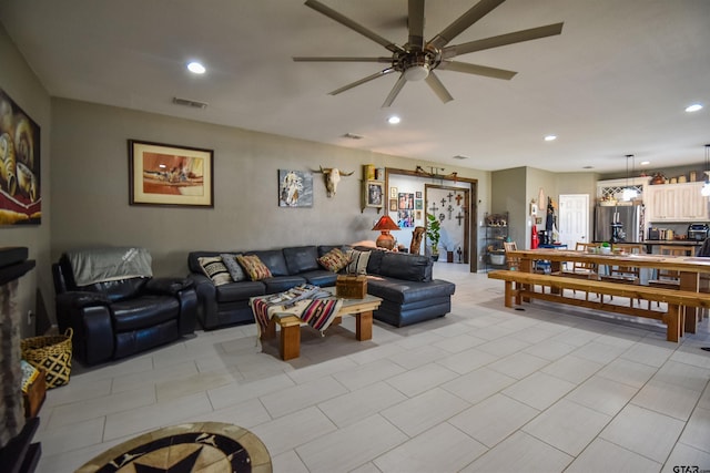 living area featuring a ceiling fan, visible vents, and recessed lighting