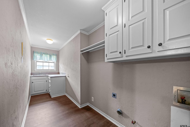 5806 Plantation Dr, Tyler, TX 75703 - washroom featuring hookup for an electric dryer, dark wood-type flooring, crown molding, cabinet space, and baseboards