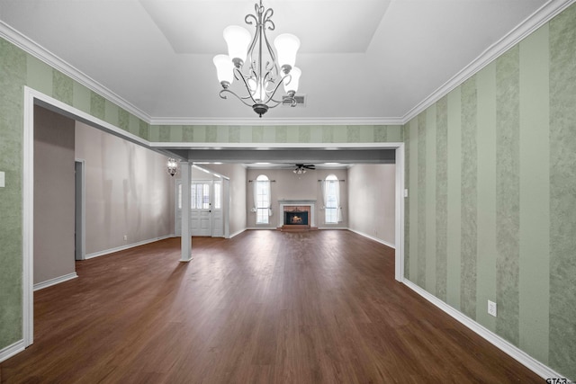 5806 Plantation Dr, Tyler, TX 75703 - unfurnished living room with a chandelier, wood finished floors, a warm lit fireplace, wallpapered walls, and baseboards