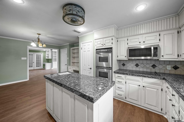 5806 Plantation Dr, Tyler, TX 75703 - kitchen with appliances with stainless steel finishes, ornamental molding, decorative backsplash, dark wood-style floors, and baseboards