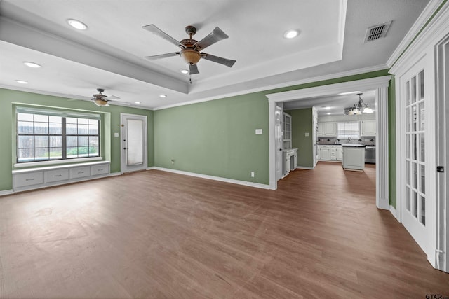 5806 Plantation Dr, Tyler, TX 75703 - spare room with ornamental molding, ceiling fan, a tray ceiling, dark wood-style floors, and a chandelier
