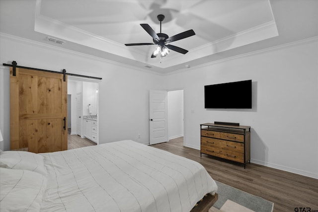 2736 Royal Village Way, Tyler, TX 75701 - bedroom featuring a tray ceiling, a barn door, wood finished floors, ornamental molding, and a ceiling fan