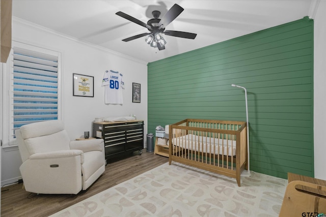 2736 Royal Village Way, Tyler, TX 75701 - bedroom with wood finished floors, crown molding, a crib, and ceiling fan