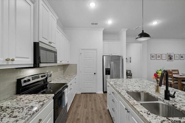 2736 Royal Village Way, Tyler, TX 75701 - kitchen featuring stainless steel appliances, ornamental molding, white cabinets, decorative backsplash, and wood finished floors
