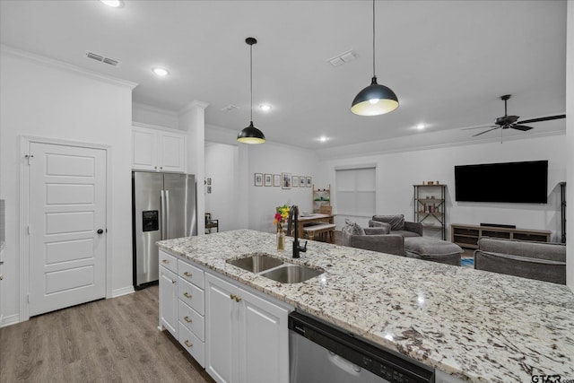 2736 Royal Village Way, Tyler, TX 75701 - kitchen featuring stainless steel appliances, ornamental molding, white cabinetry, wood finished floors, and ceiling fan
