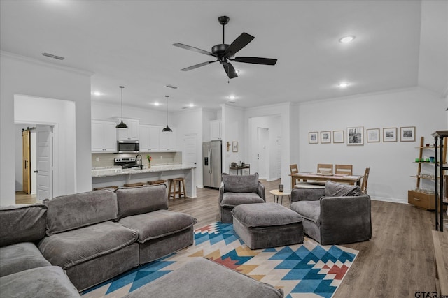 2736 Royal Village Way, Tyler, TX 75701 - living area with ornamental molding, wood finished floors, a ceiling fan, and recessed lighting