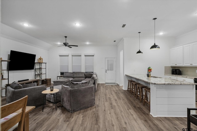 2736 Royal Village Way, Tyler, TX 75701 - living area with a ceiling fan, wood finished floors, recessed lighting, and crown molding