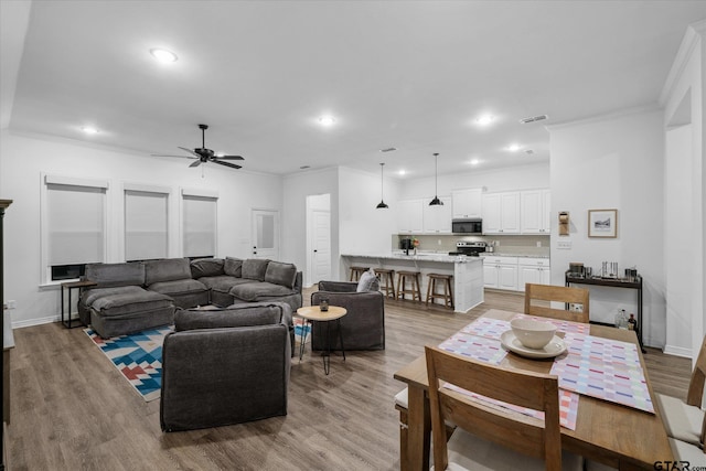 2736 Royal Village Way, Tyler, TX 75701 - living room with ceiling fan, crown molding, light wood finished floors, and recessed lighting