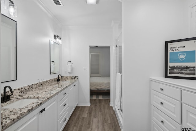 2736 Royal Village Way, Tyler, TX 75701 - full bathroom featuring wood finished floors, double vanity, crown molding, and a shower with shower door