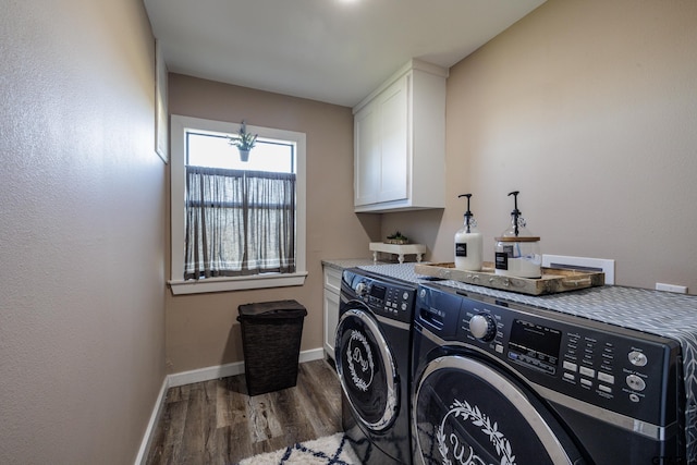 washroom featuring separate washer and dryer, cabinets, and dark hardwood / wood-style floors