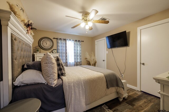 bedroom with ceiling fan and dark wood-type flooring