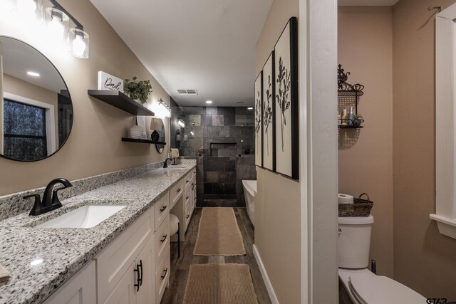 bathroom with vanity, wood-type flooring, an enclosed shower, and toilet