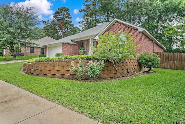 9196 Teal Flight Way, Tyler, TX 75703 - view of property exterior featuring a yard, brick siding, an attached garage, and fence