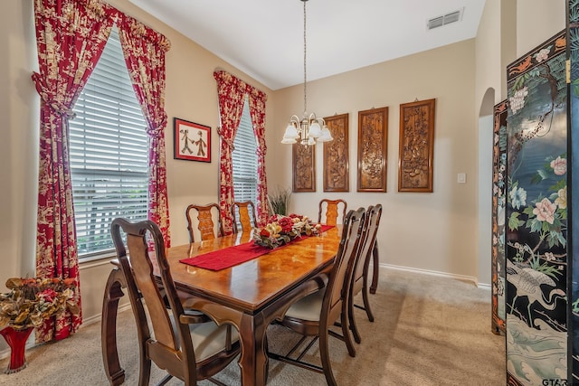 9196 Teal Flight Way, Tyler, TX 75703 - dining space with baseboards, an inviting chandelier, visible vents, arched walkways, and light colored carpet