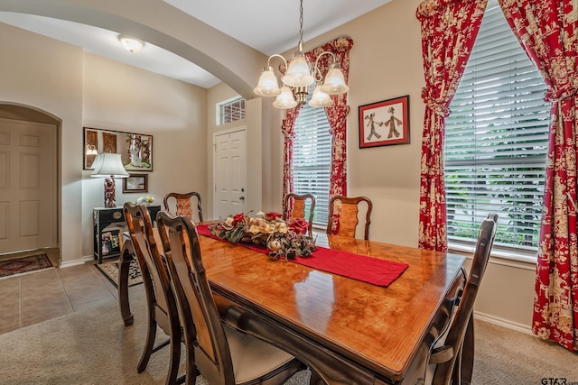9196 Teal Flight Way, Tyler, TX 75703 - dining area with arched walkways, light carpet, baseboards, and an inviting chandelier