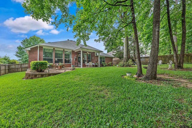 9196 Teal Flight Way, Tyler, TX 75703 - back of house featuring a lawn, a patio, brick siding, and a fenced backyard