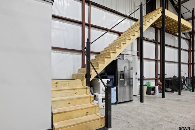 staircase with concrete flooring