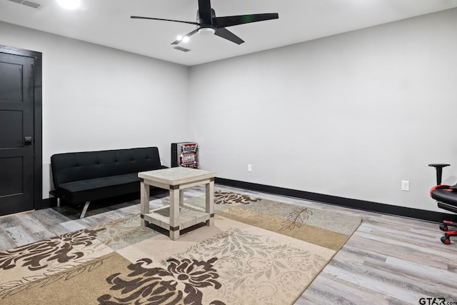 sitting room featuring ceiling fan and hardwood / wood-style flooring