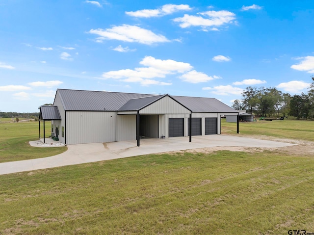 view of front facade with a garage, a front lawn, and an outdoor structure