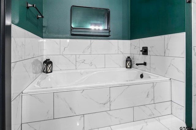 bathroom with a relaxing tiled tub