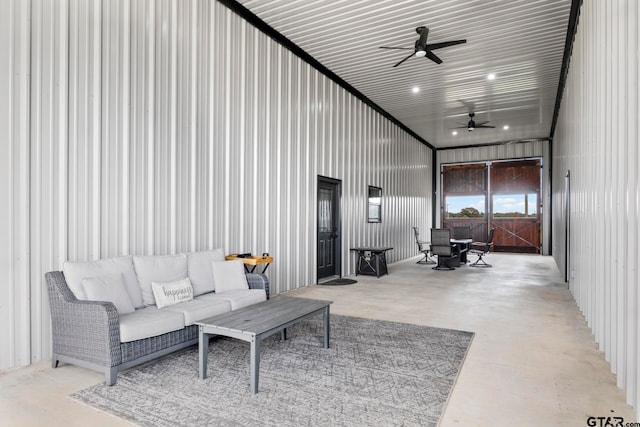 living room featuring a towering ceiling and ceiling fan