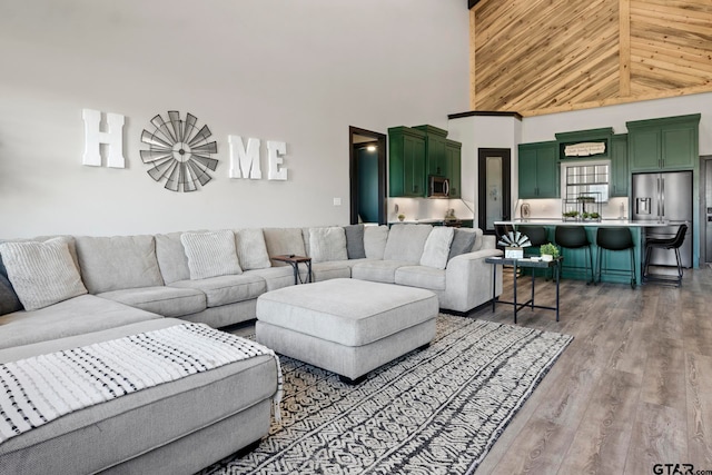 living room with hardwood / wood-style flooring and high vaulted ceiling