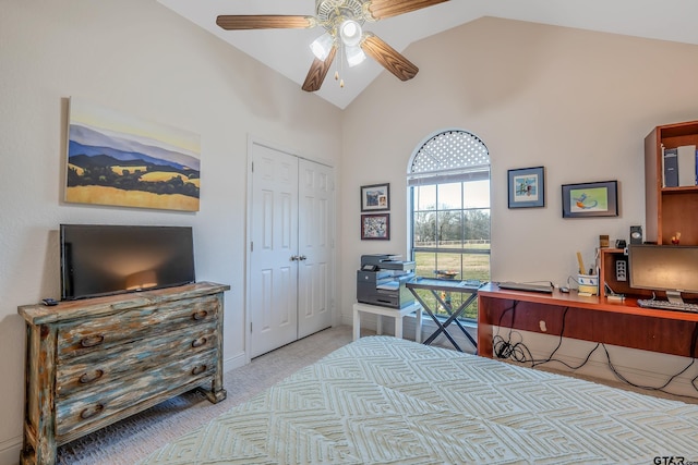 carpeted bedroom featuring ceiling fan, a closet, and high vaulted ceiling